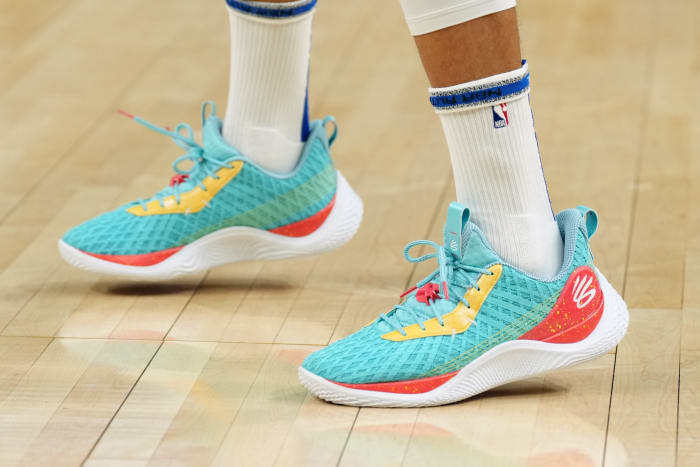 View of Stephen Curry's teal and red Under Armour shoes.